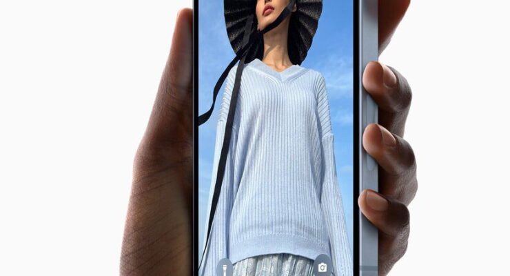 A hand holds up the new iPhone 14 Plus.,